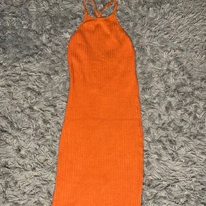 Orange backless mini dress with crisscrossing Back